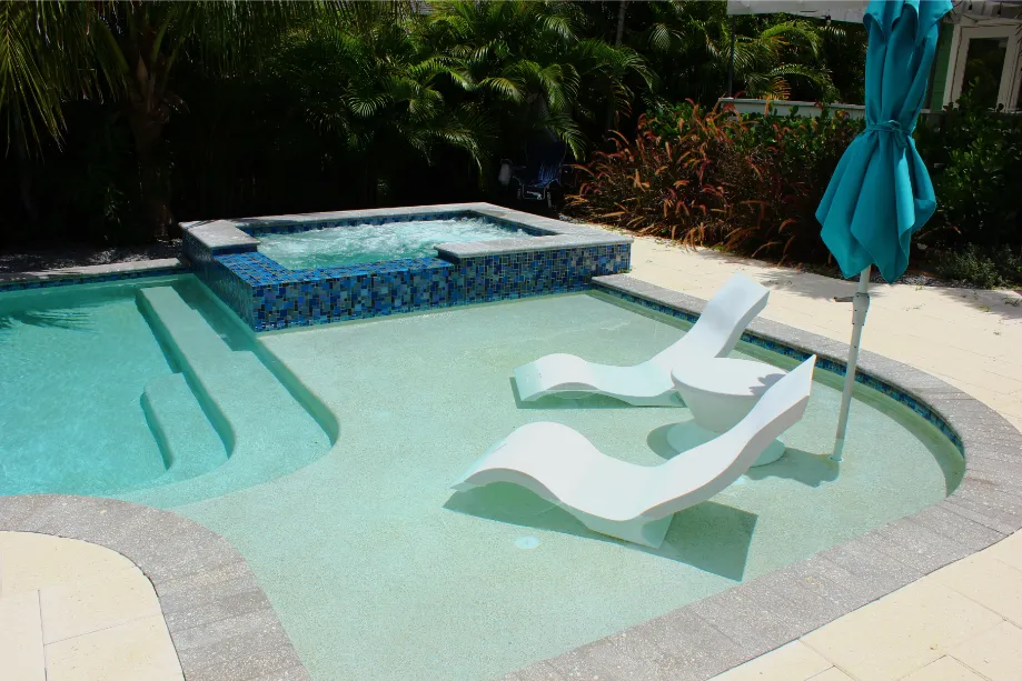 Raised built-in spa flowing into a backyard pool in the Tampa Bay area
