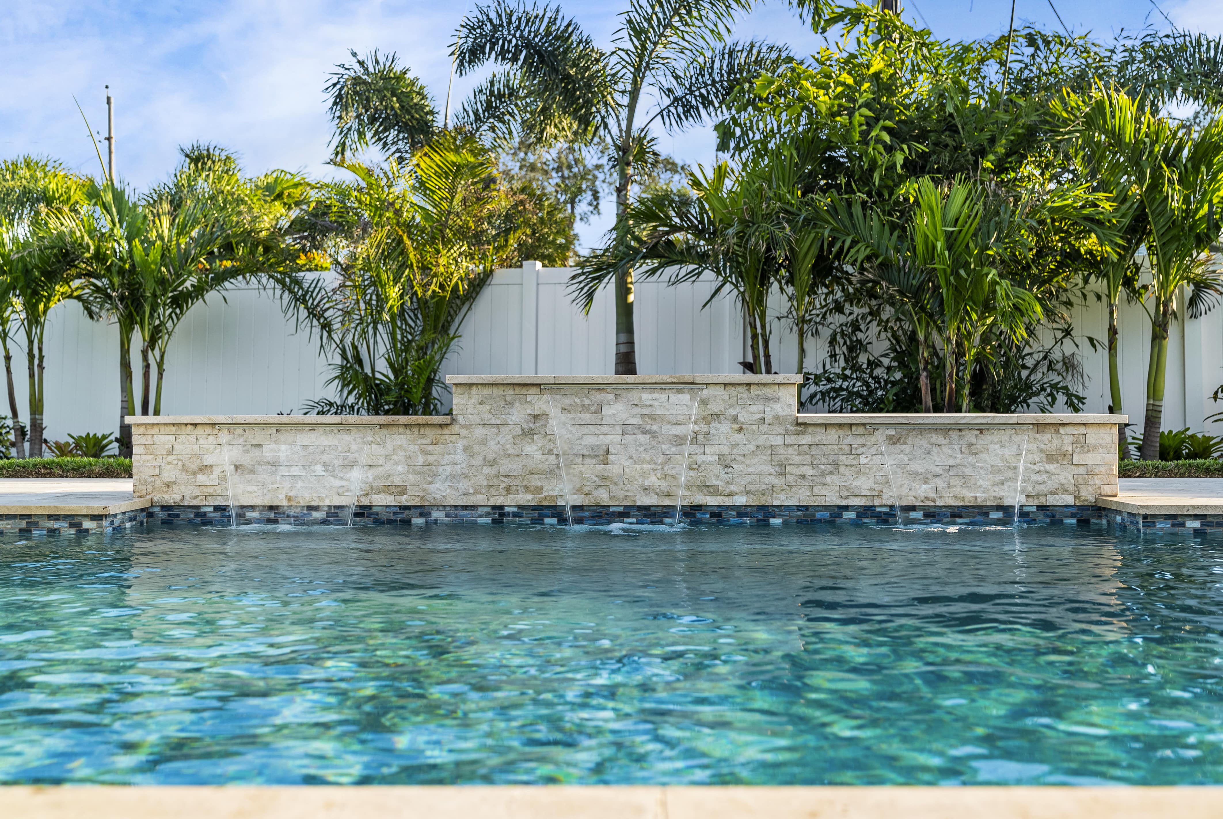 swimming pool with plants on the side